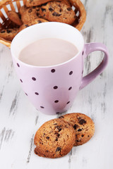 Cocoa drink and cookies on wooden background