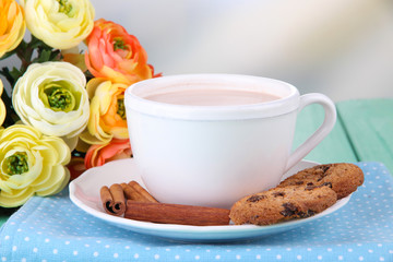 Cocoa drink  and cookies on wooden  table, on bright background