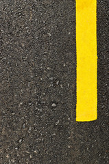 Closeup new asphalt road with yellow line