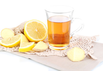 Cup of tea with ginger on napkin isolated on white