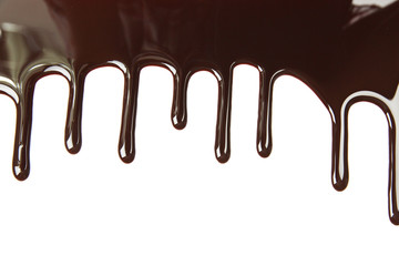 Melted chocolate dripping on white background