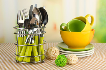 Kitchen cutlery in metal stand with clean dishes