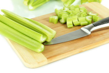 Fresh green celery on cutting board close-up