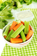 Fresh green celery with vegetables in bowl on table close-up