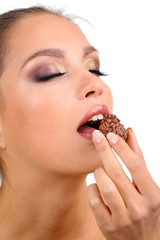 Portrait of beautiful young girl with chocolate candy isolated