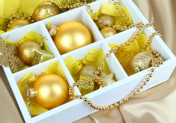 Christmas toys in wooden box on bright background