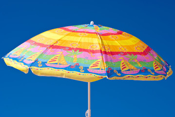 Colorful parasol at the background of blue sky