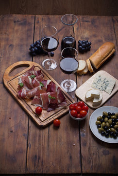 sliced prosciutto with red wine and olives