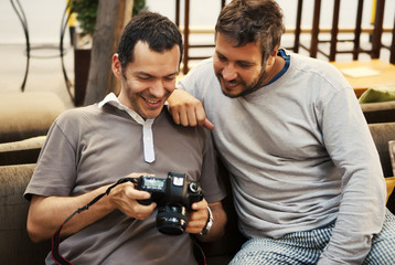 Two friends looking at photos in camera