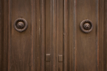 Old wooden door with round brass door handles