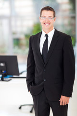 young businessman standing in office