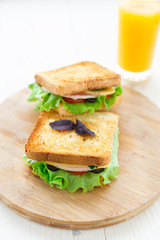 Sandwich with ham, cheese, tomatoes and lettuce