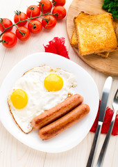 Fried eggs with sausages.
