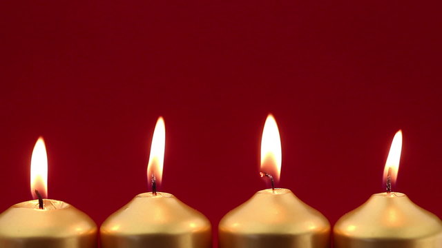 Gold advent candles with red background