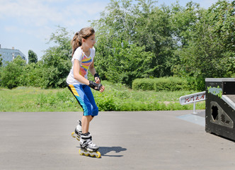 Pretty young teenage girl roller skating