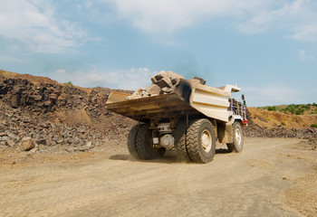 A granite quarry mine with a tipper lorry transporting stones