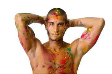 Attractive young man shirtless, skin painted with bright colors