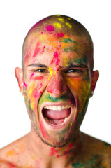 Young man screaming with face's skin painted with colors