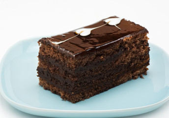 A piece of chocolate cake on a blue plate