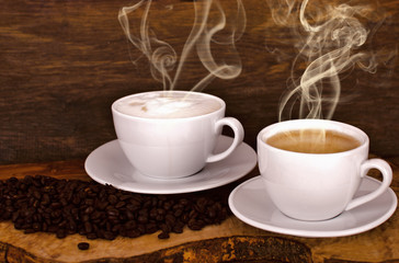 Coffee beans and coffee cup on old wooden background