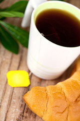 cup of tea and fresh croissant