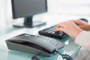 Close up of a businesswoman typing on a keyboard