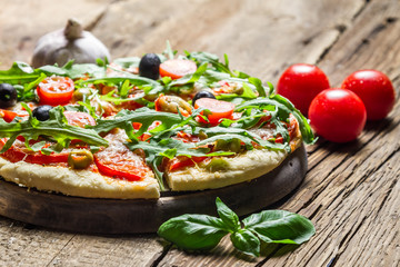 Freshly baked pizza with basil and tomatoes