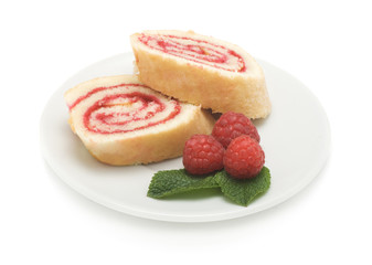Sweet roll cake with raspberry jam and berries, isolated on a wh
