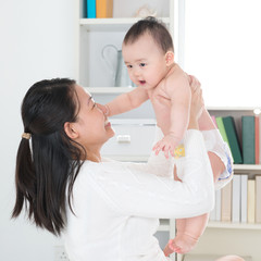 Asian mother and baby at home.