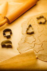 Cutting of different shapes of gingerbread cookies