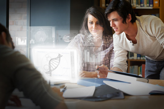 Concentrated students analysing dna on digital interface - Powered by Adobe