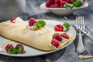 Raspberry pancakes sprinkled with icing sugar