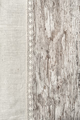 Linen fabric with lace on the old wooden background