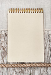 Notebook, rope and linen fabric on the old wood