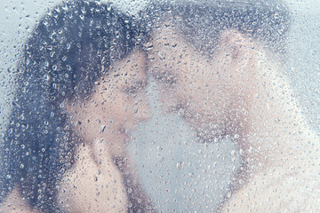 Loving couple in shower. Beautiful young loving couple hugging w