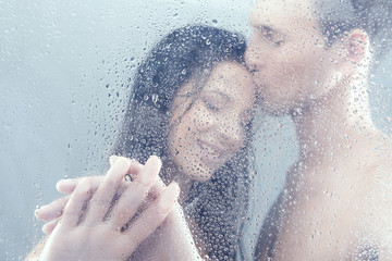 Loving couple in shower. Beautiful loving couple hugging while s