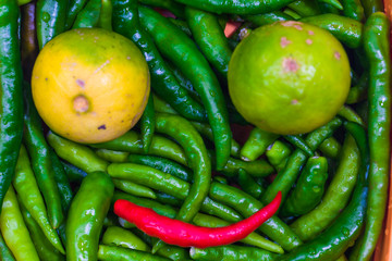Close up of Green Chilli Peppers and lemon