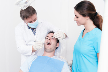 Dental surgery. There's a dentist, his assistant and the patient