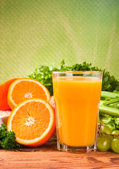 Fresh fruits, vegetables and juice on wood