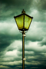 Fototapeta na wymiar Old lamp on a cloudy day