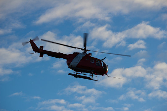 Red and white helicopter against nice sky