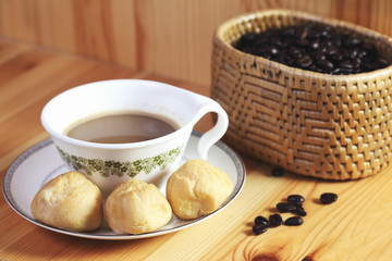 Bread Eclair with coffee on the wooden