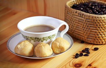 Bread Eclair with coffee on the wooden