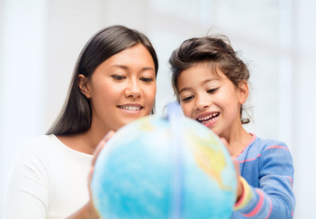 mother and daughter with globe