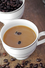 Coffee cup and coffee bean on a wooden table