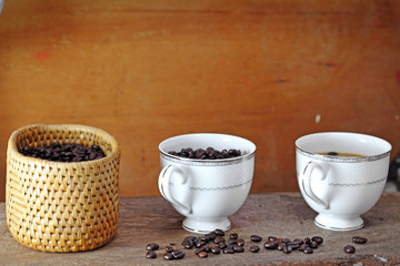 Coffee cup and coffee bean on a wooden table