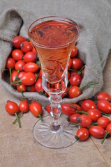 Rosehip fruit and alcoholic liquor in a glass