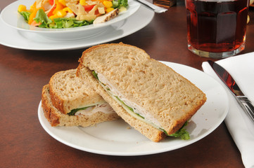 Turkey and swiss sandwich with a salad