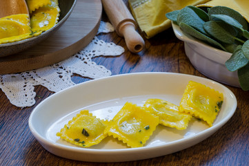 homemade ravioli pasta with sage butter sauce , italian food