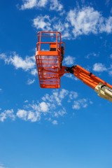 Vertical Shot of an Orange Hydraulic Construction Lift